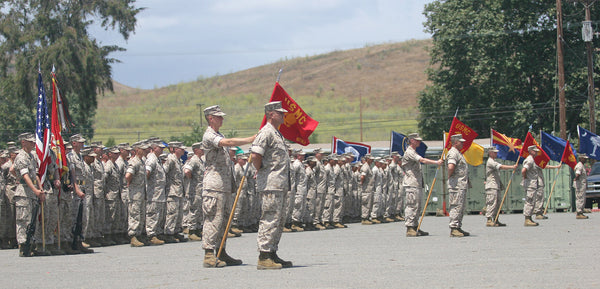 Marines from the 3rd Battalion, 1st Marine Regiment, 1st Marine Division, stand in formation awaiting the presentation of the Navy Cross medal to former Marine Sgt. Robert J. Mitchell during a ceremony aboard Camp Pendleton, Calif., July 28, 2006.