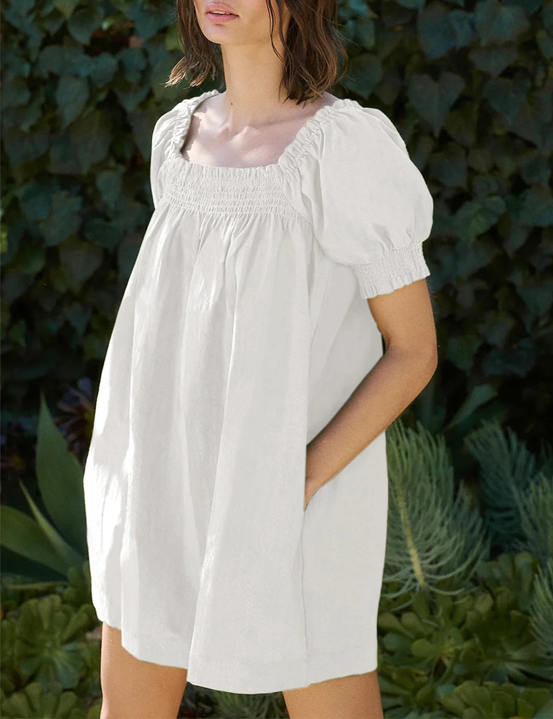 Showing the puff sleeve and square neck fit of Riley