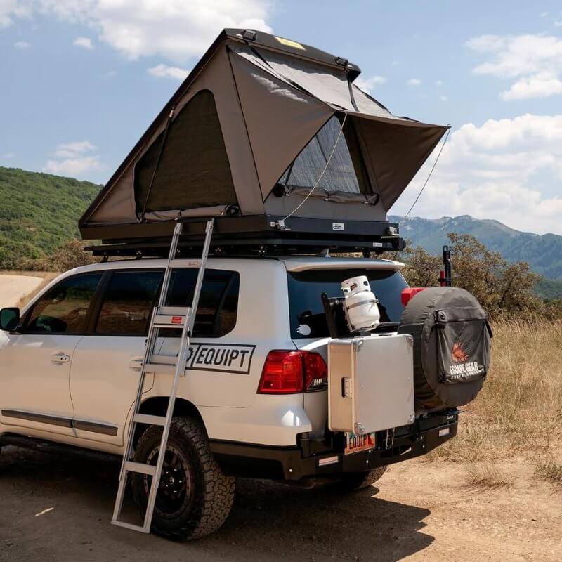eezi-awn-blade-hard-shell-roof-top-tent-open-side-view-on-vehicle-with-extendable-ladder-in-nature
