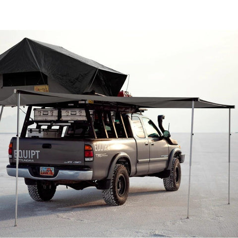 eezi-awn-manta-270-awning-gray-open-rear-corner-view-on-toyota-tundra-with-soft-shell-rooftop-tent-in-nature