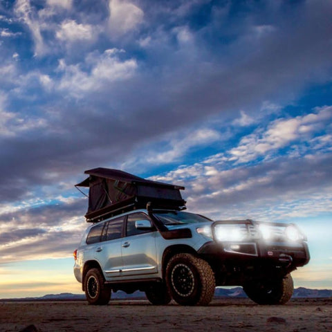 eezi-awn-stealth-hard-shell-roof-top-tent-open-front-corner-view-on-toyota-sequoia-in-desert-at-dusk