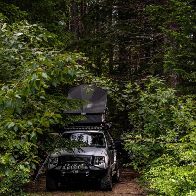 eezi-awn-stealth-hard-shell-roof-top-tent-open-front-view-on-ford-explorer-in-nature