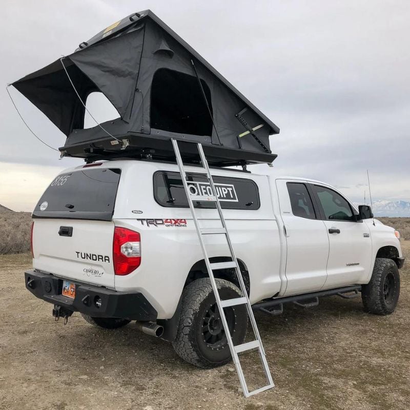 eezi-awn-stealth-hard-shell-roof-top-tent-open-rear-corner-view-with-rainfly-on-toyota-tundra-in-desert