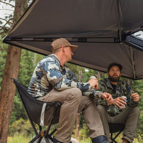 freespirit-recreation-270-awning-driver-side-open-close-up-view-of-people-camping-in-forest