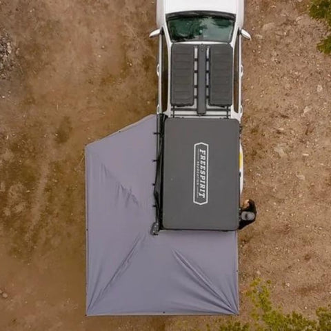 freespirit-recreation-270-awning-driver-side-open-drone-view-on-vehicle-parked-in-nature