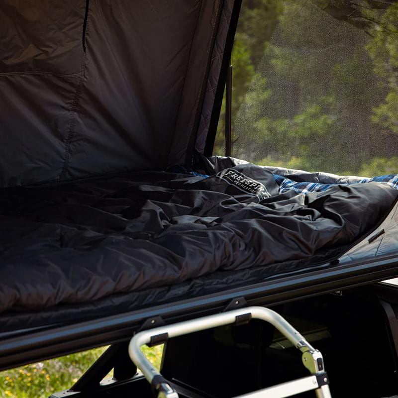 freespirit-recreation-odyssey-series-roof-top-tent-with-black-top-close-up-view-of-interior-with-mattress-and-sleeping-bag