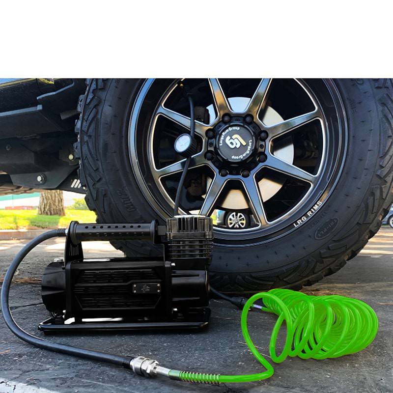 overland-vehicle-systems-egoi-5.6-cfm-air-compressor-system-inflating-a-tri-fly-tire-using-the-24-feet-green-coiled-hose-outdoor