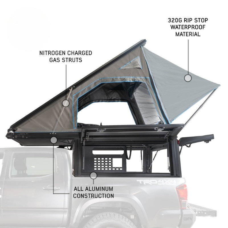 overland-vehicle-systems-magpak-camper-shell-roof-top-tent-for-ford-ranger-open-side-view-on-vehicle-gas-struts-on-white-background