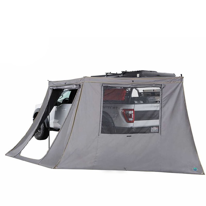 overland-vehicle-systems-nomadic-180-lte-awning-wall-with-windows-open-rear-corner-view-on-vehicle-with-rolled-up-doors-on-white-background