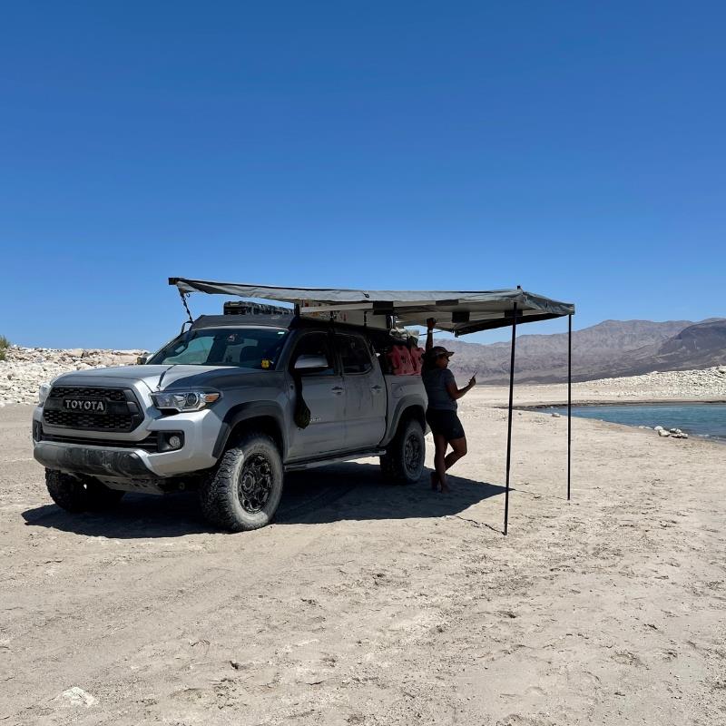 overland-vehicle-systems-nomadic-awning-180-for-mid-high-roofline-vans-side-view-on-toyota-in-nature