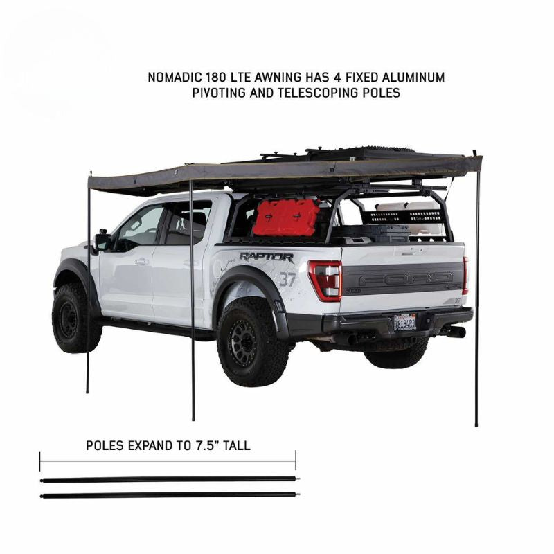 overland-vehicle-systems-nomadic-awning-180-lte-gray-open-rear-corner-view-on-ford-raptor-with-telescoping-poles-on-white-background