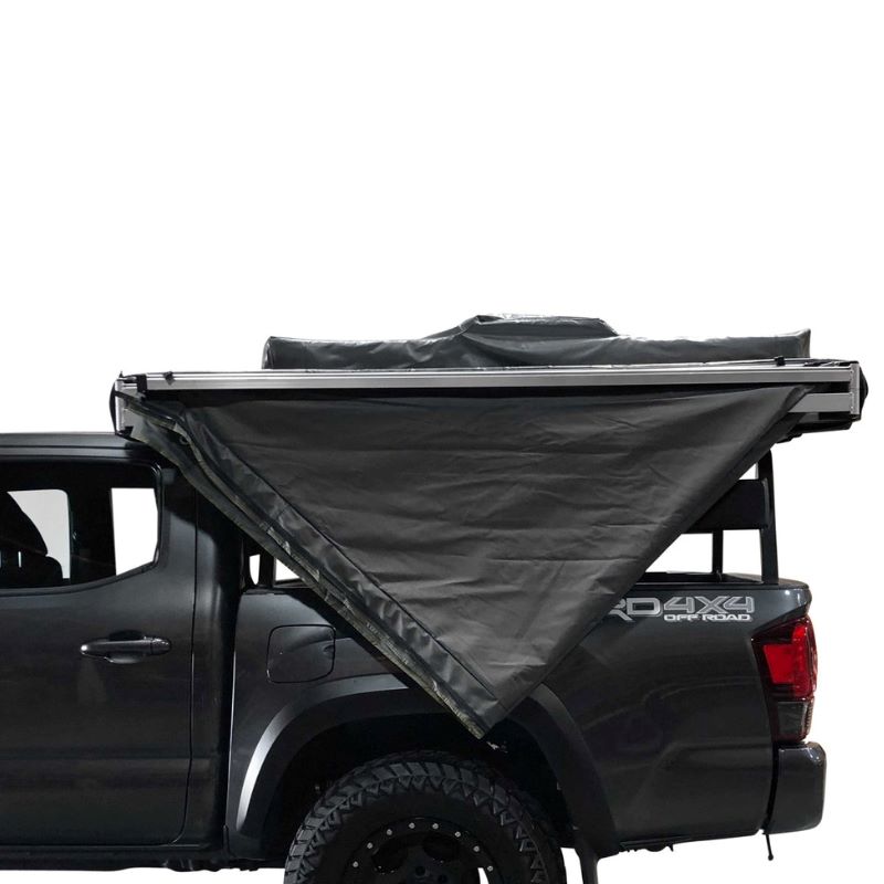 overland-vehicle-systems-nomadic-awning-270-driver-side-gray-semi-closed-and-folded-side-view-on-toyota-tacoma