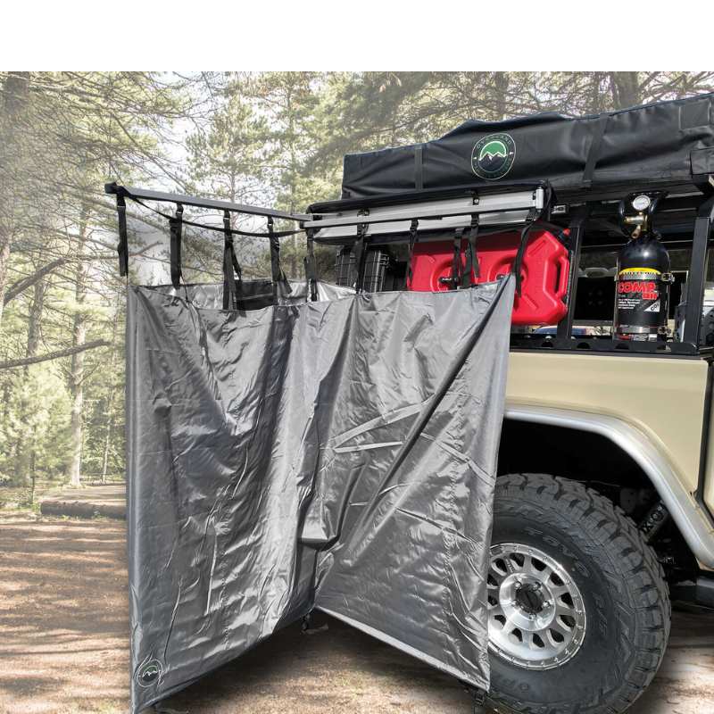 overland-vehicle-systems-nomadic-car-side-shower-room-open-folded-rear-corner-view-beside-vehicle-in-nature