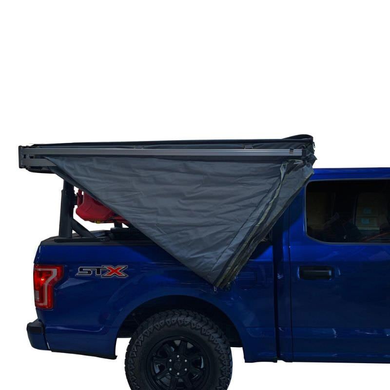 overland-vehicle-systems-nomadic-lt-270-awning-with-walls-passenger-side-semi-open-side-view-on-ford-ranger-with-travel-bag-unzipped