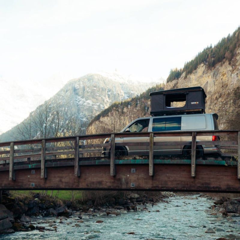 tentbox-classic-hard-shell-roof-top-tent-gray-open-side-view-on-volkswagen-caravelle-in-nature