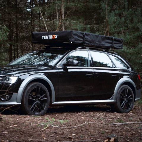 tentbox-lite-xl-soft-shell-roof-top-tent-closed-front-corner-view-on-audi-a4-in-the-woods