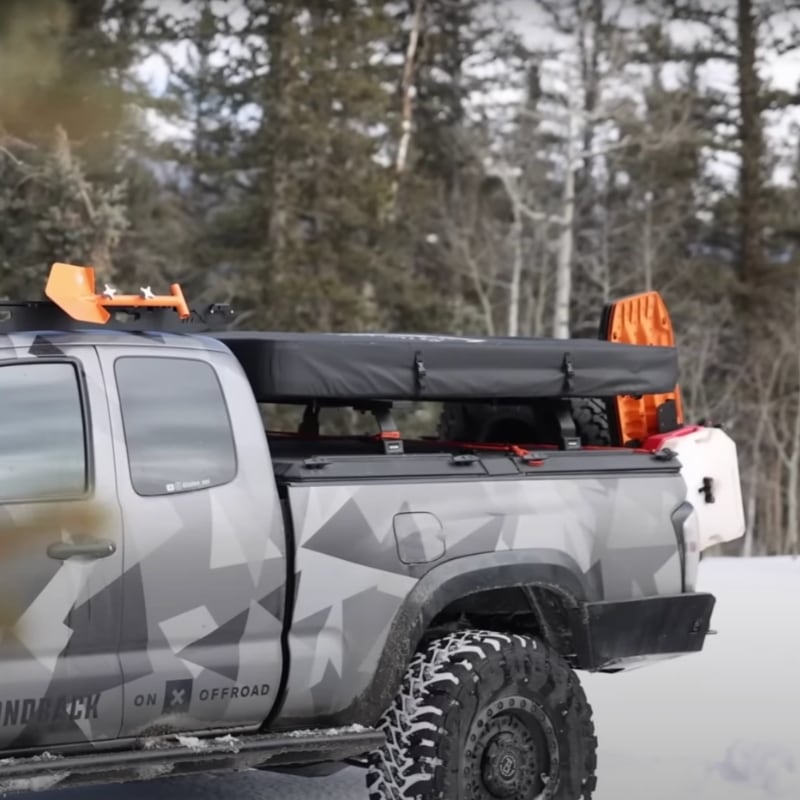 freespirit-recreation-aspen-lite-hard-shell-roof-top-tent-black-closed-front-corner-view-on-truck-in-forest-with-snow1