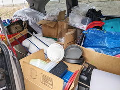 Back of van packed with household items being dropped off at a donation center