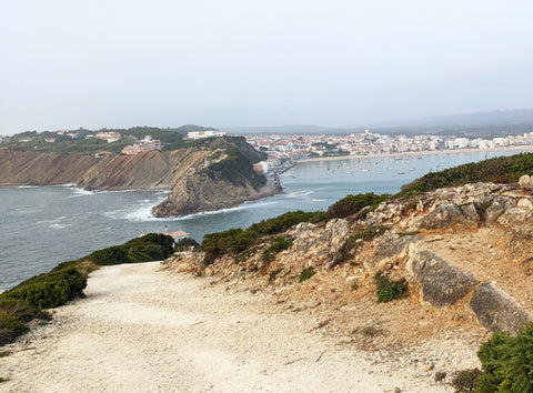 Tiny chapel at the end of a dirt road with the Atlantic ocean on the left and the bay of Sao Martinho do Porto on the right