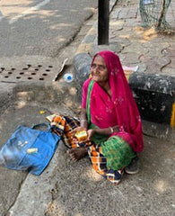 Image of older woman sitting on the ground