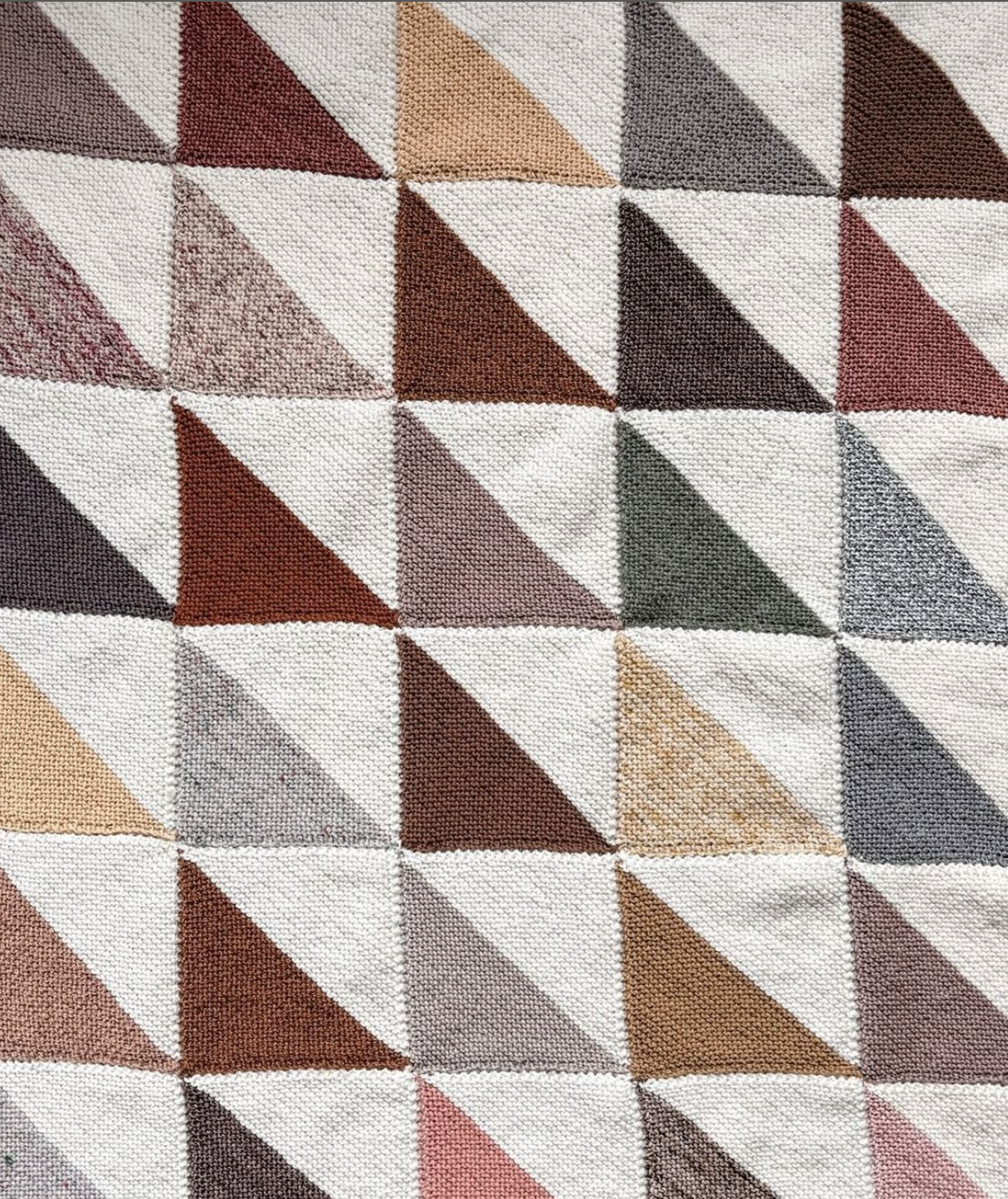 geometric hand knit blanket in earthy tones