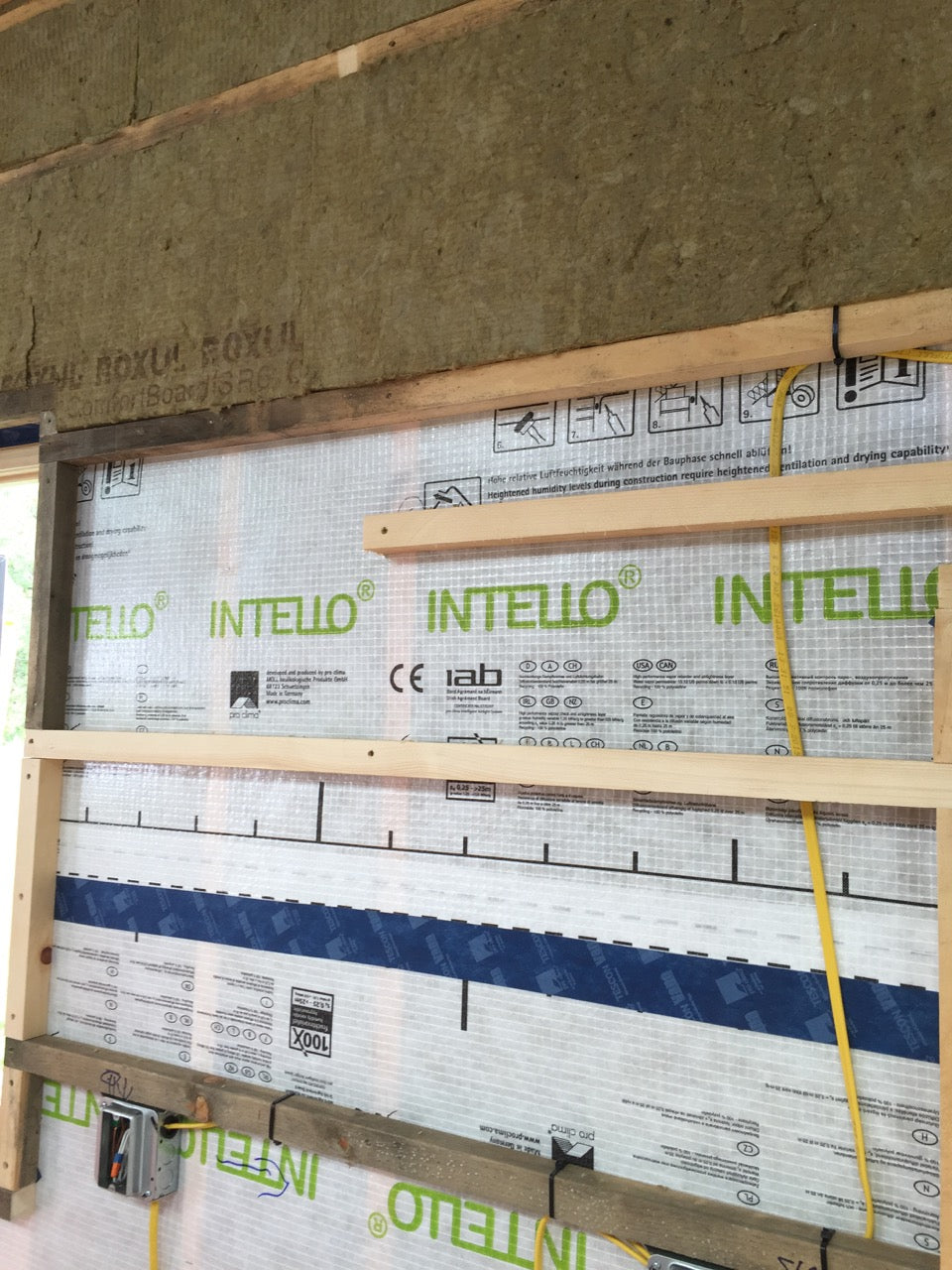 Comfort batts in stud bays, continuous Intello air barrier, horizontal 2x2 furring strips creating utility chase, 1.5" comfort batt