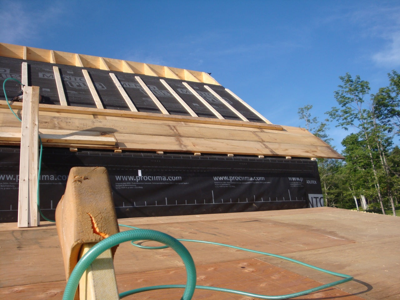 The wood roof sheathing was added in stages for solid footholds as work progressed 