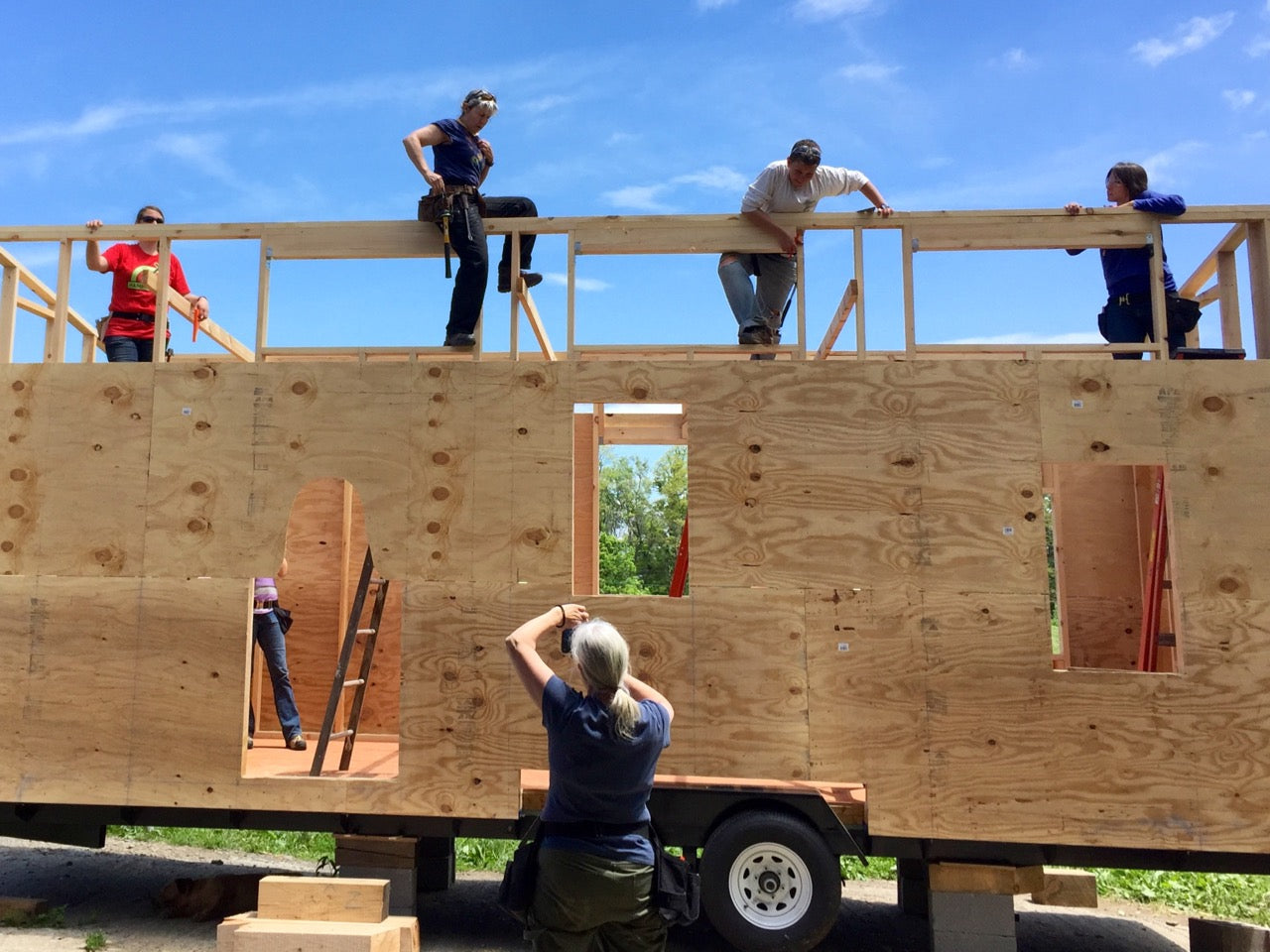 Tiny House being raised and sheathed