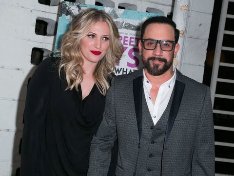 AJ McLean and Rochelle Deanna Karidis smiling together at a red carpet event, looking happy and in love