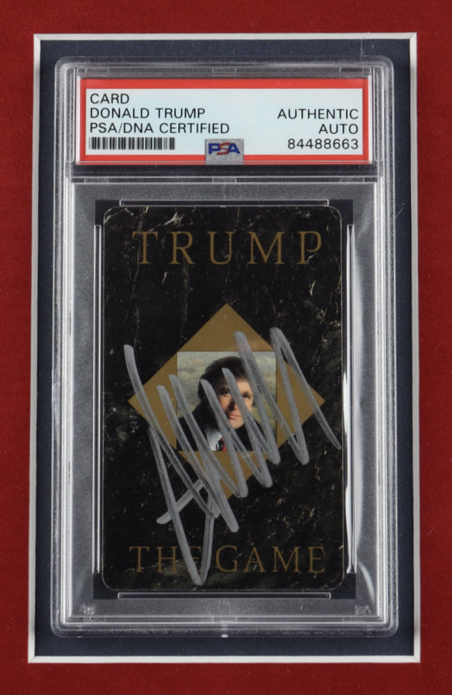 Custom framed display featuring a hand-signed card from 'Trump The Game' by former President Donald Trump, with the item authenticated and encapsulated by PSA/DNA, currently on auction