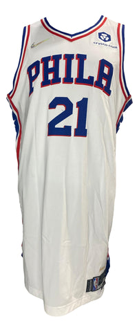 A Philadelphia 76ers on-court style jersey, size XXL, displayed in a frame. This jersey was worn during a game by Joel Embiid against the Utah Jazz on December 9, 2021. The jersey exhibits visible signs of game use. An official Fanatics hologram for authenticity purposes is attached to the jersey