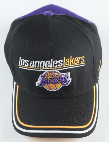 Close-up view of a Los Angeles Lakers fitted hat, adorned with the unique signatures of Kobe Bryant and Lamar Odom. The hat's bold purple color serves as a testament to Lakers' pride and is further emphasized by the official James Spence Authentication (JSA) hologram, certifying its authenticity