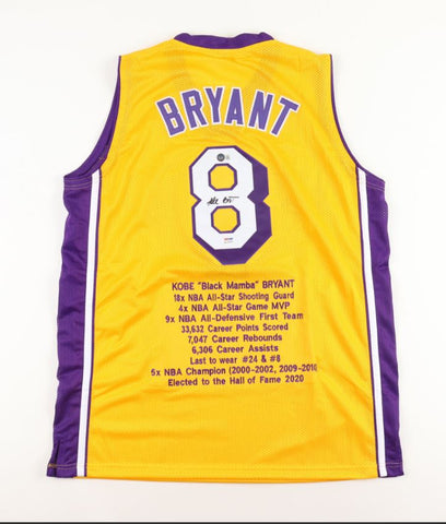 An authentic signed Kobe Bryant career highlights jersey, size XL, displayed against a neutral backdrop. The high-quality stitching and intricate details of the jersey are prominently showcased