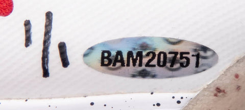 A close-up view of the game-used, signed and inscribed sneakers worn by LeBron James during the 2013 Eastern Conference Finals, highlighting their vibrant colors, design features, and signs of wear against a neutral background