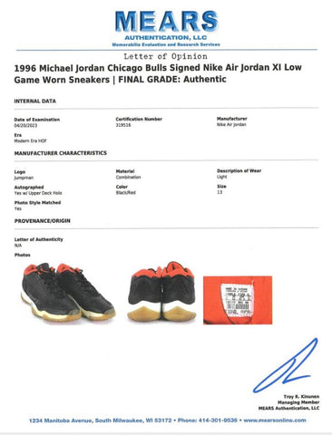 A detailed shot of the 1996 game-used, signed Nike Air Jordan XI sneakers, showcasing their iconic design and the light wear indicative of their use on the basketball court