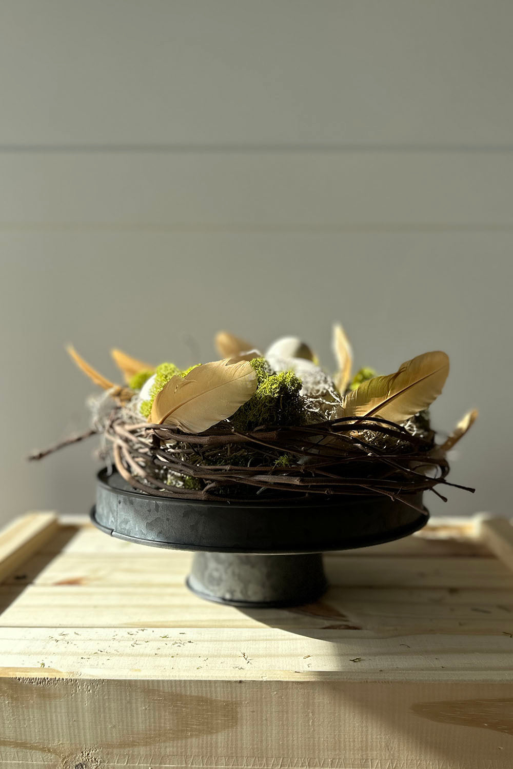 spring lane riser display with moss, grapevine, ceramic eggs and feathers