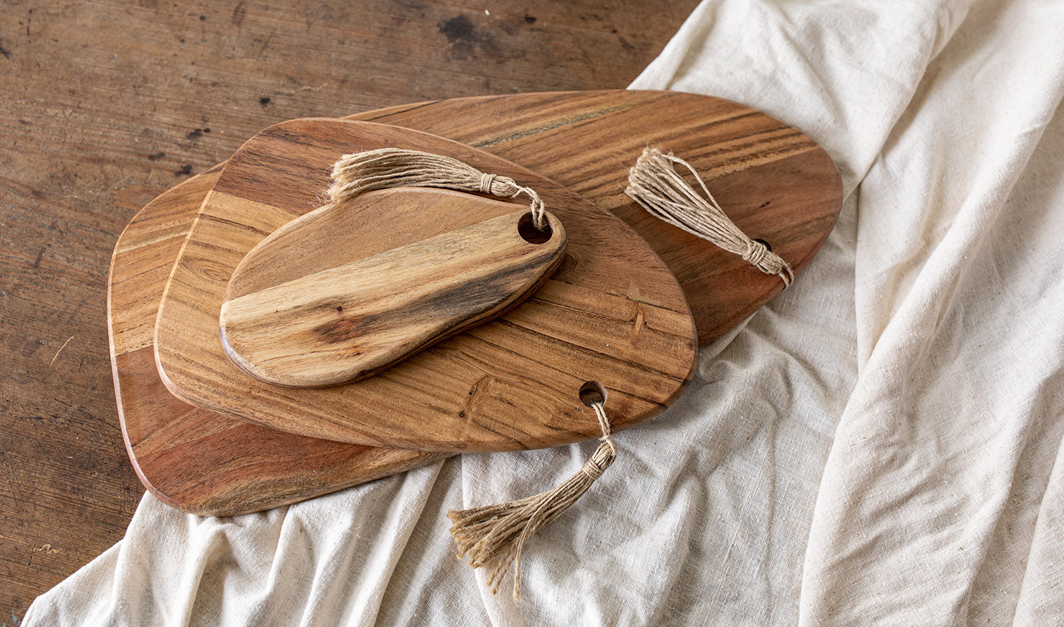 stack of prairie cutting boards on table with tablecloth