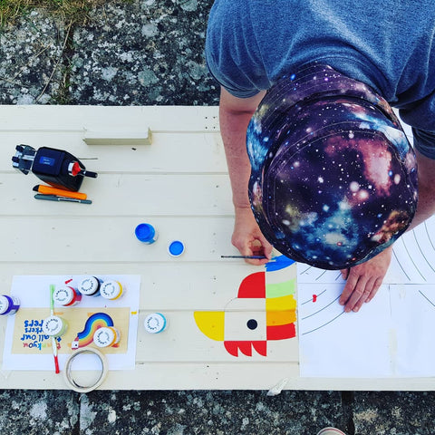 Andy Tuohy hand painting a sign