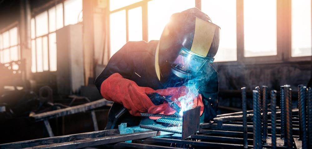 Welder using 6013 welding rod in factory