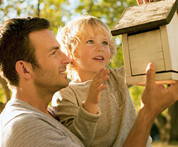 father teaching son about wild birds