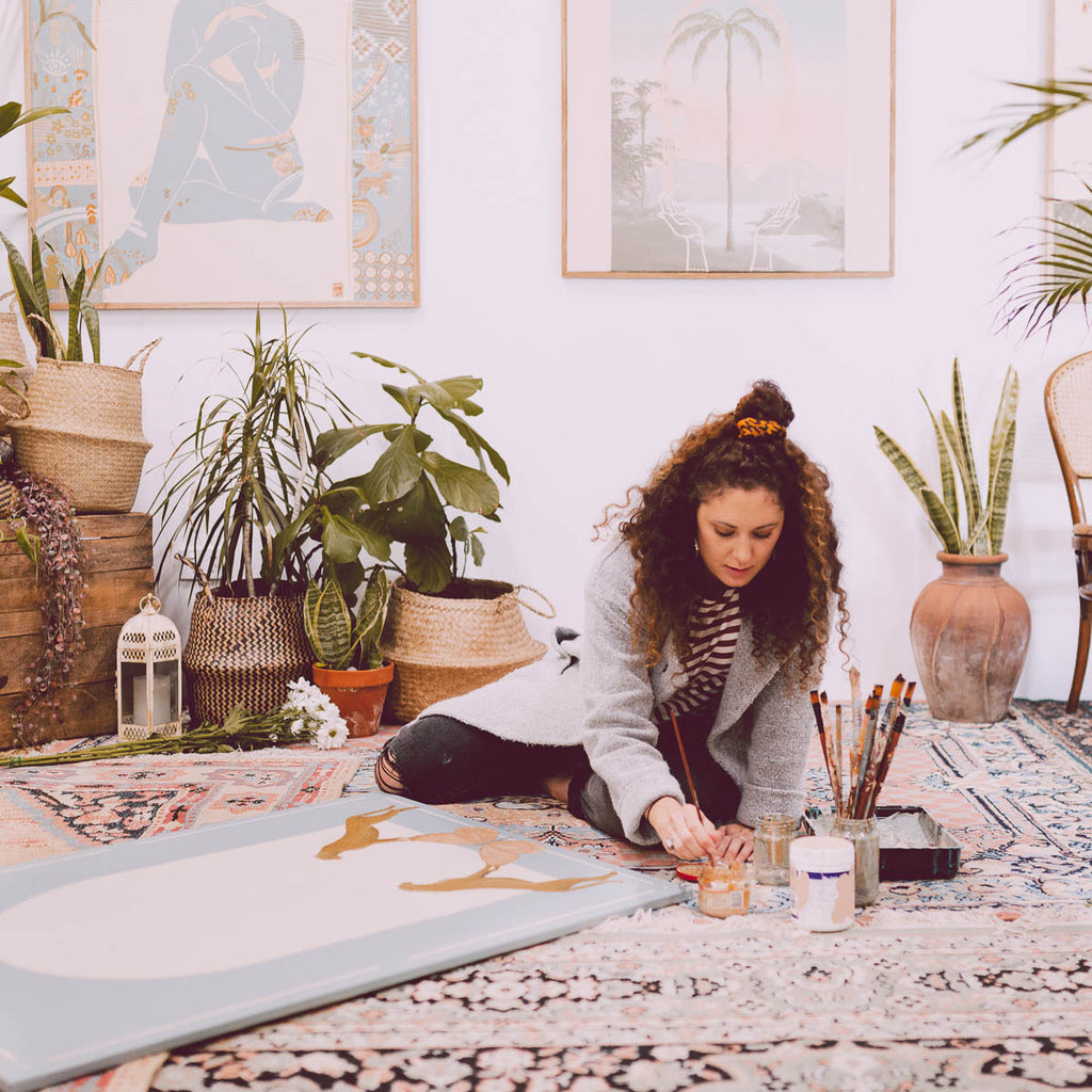 Artist Tahnee Kelland painting in her studio