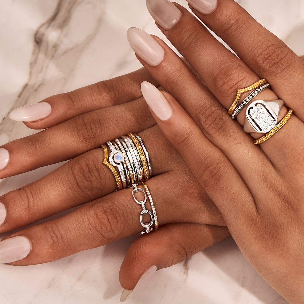 gold and silver rings layered in a boho style ring stack