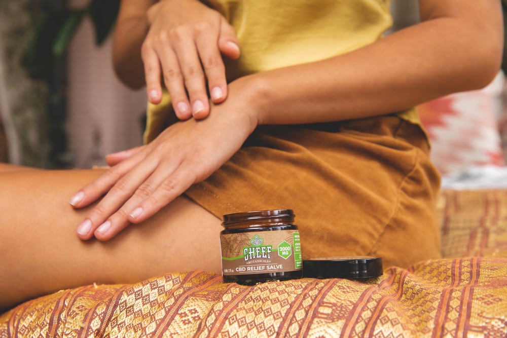 woman putting on cbd salve