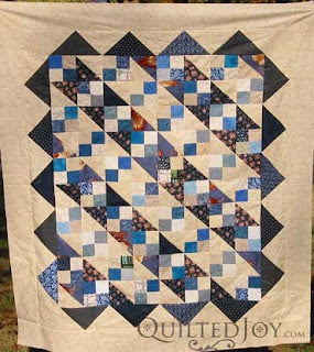 Scrappy quilt top waiting in the wings by Angela Huffman