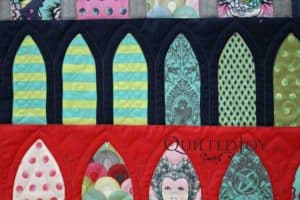 Longarm quilter Angela Huffman filled the simpler arches with motifs such as a stacked curls and ribbon candy