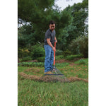 24 inch tine fiberglass handle lawn rake being used by a person.