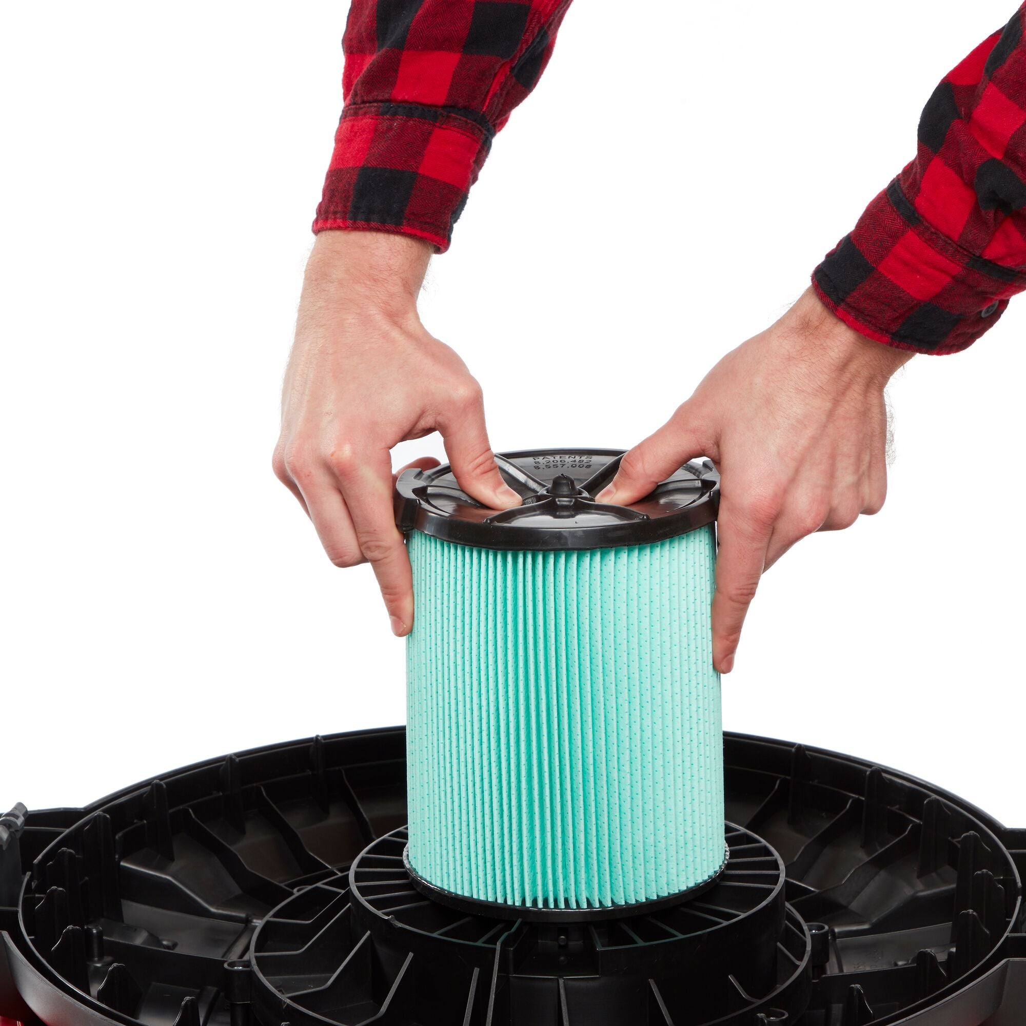 Person installing CRAFTSMAN HEPA Media Replacement Filter onto wet/dry shop vac powerhead