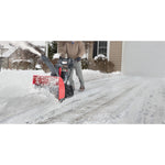 26 inch 208 CC electric start track drive snow blower being used.