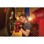 Cordless half inch impact wrench kit 1 battery being used to tighten tyre screws by person.