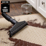 Person using 1-7/8 inch floor brush with CRAFTSMAN shop vac to cleanup coffee grounds on floor